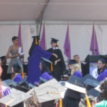 Walking across the stage, ready to hug Prof. Tag!